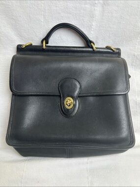 Coach Black Leather Turn-Lock Top-Handle bag with shoulder strap